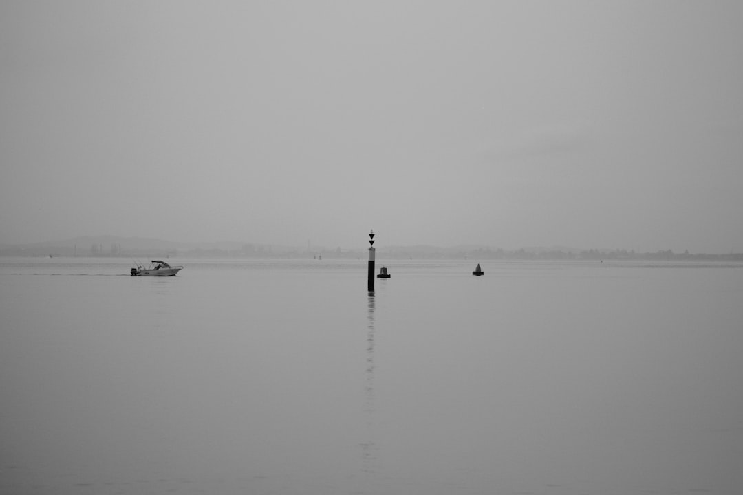 white power boat in the middle of the water