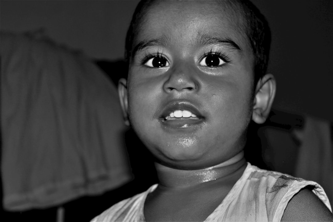 A young child with wide eyes and an open mouth.
