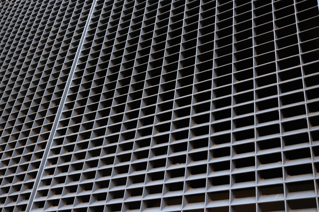 a close up of a metal grate on the side of a building